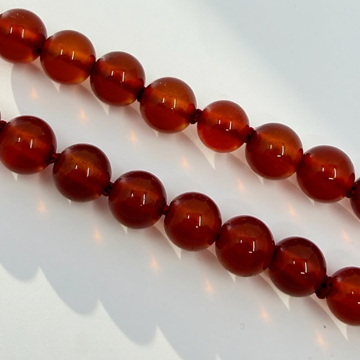 CARDINALE gold and carnelian hand-knotted necklace with charm