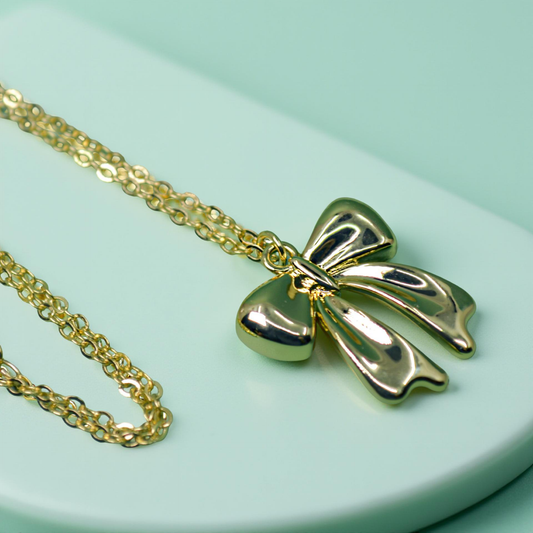 CLARA gold bow pendant