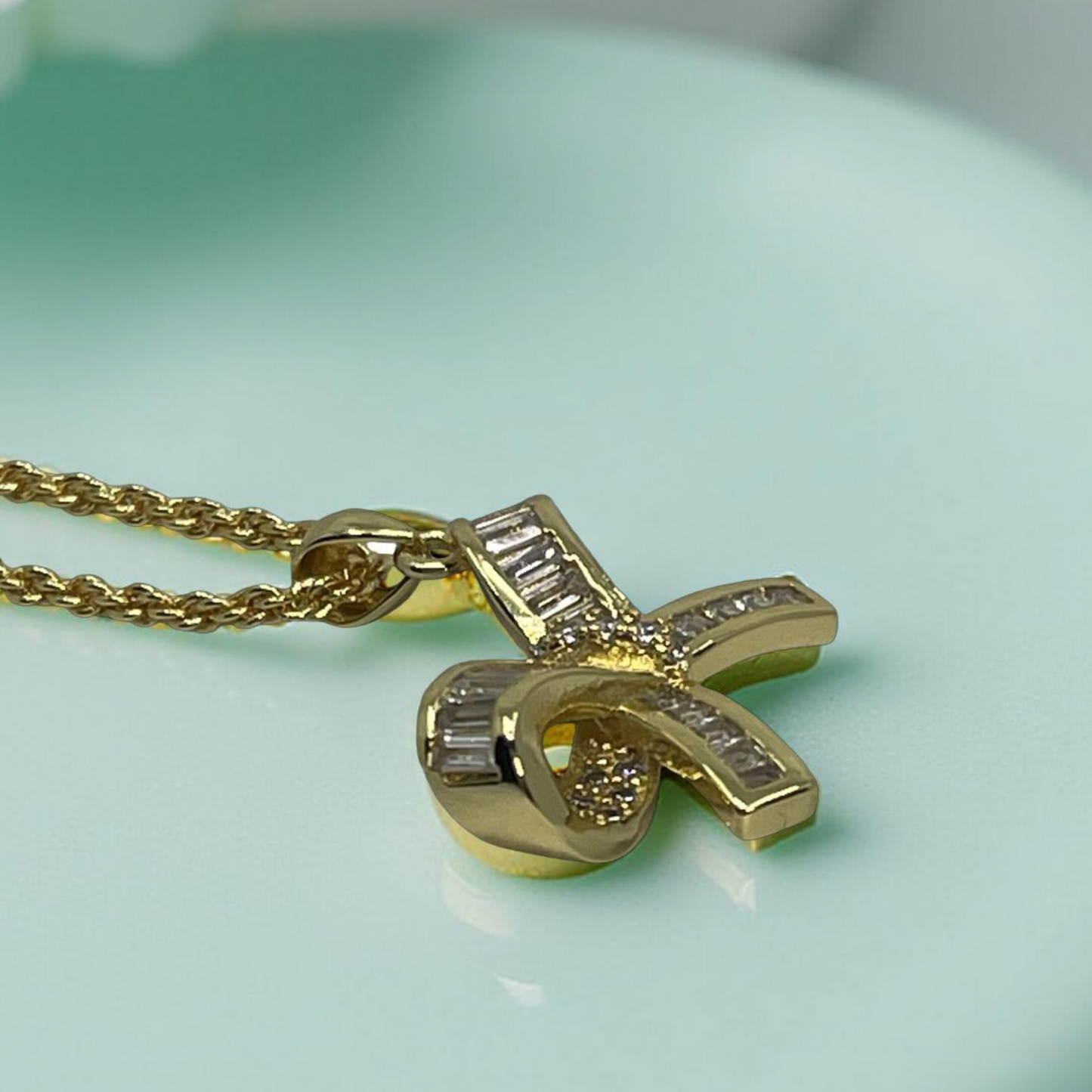 LARA gold and pave baguette cz bow pendant
