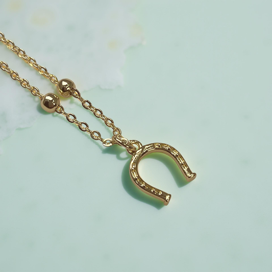 LUCKY gold horseshoe pendant on satellite chain